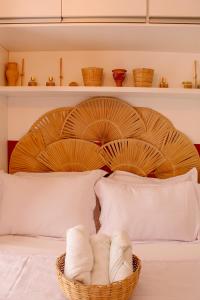 a basket of towels sitting on a bed at Axé home - Apartamento conceito em Salvador in Salvador +48 photos