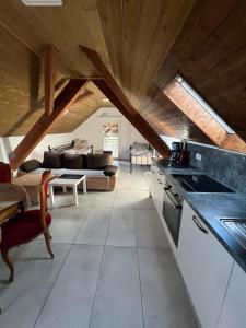 a kitchen and living room with wooden ceilings at Mira Home 3 in Murg