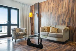 a living room with a couch and a table and a chair at Colosseum Hotel in Cape Town