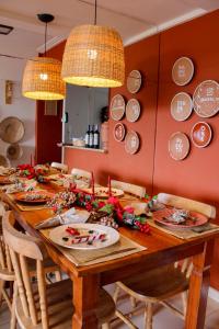 a dining room table with dishes on the wall at Axé home - Apartamento conceito em Salvador in Salvador