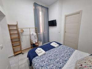 a bedroom with a bed with two towels on it at Il Fondaco all'Archivio Storico in Naples +95 photos