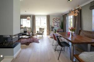 a living room with a table and a dining room at Ferienhaus Sylt Leev in Westerland
