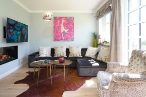a living room with a couch and a table at Ferienhaus Sylt Leev in Westerland