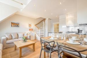 a kitchen and living room with a table and chairs at Ferienwohnung Tau Hus Keitum Sylt in Keitum