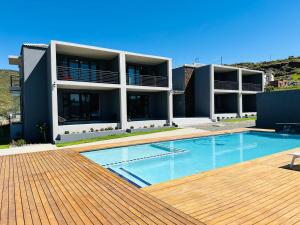 a house with a swimming pool in front of a building at Bon Voyage Inn in Sterkspruit