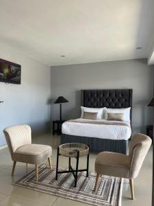 En eller flere senge i et værelse på Bon Voyage Inn