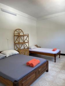 a room with two beds in a room at VaoVao Hotel in Nosy Be