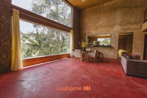 a living room with a large window and a couch at Casa na pedra em Serra Negra vista para montanha in Bezerros
