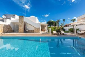 a swimming pool in front of a villa at Villa Goccia by BarbarHouse in Torre dell'Orso