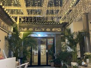 a building with christmas lights hanging from the ceiling at Dali Muqiuqingfengyunye Boutique B&B in Dali