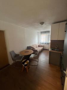 a living room with a table and a couch at Era Home in Murg