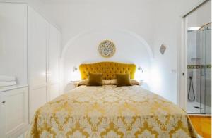 a bedroom with a large bed with a yellow bedspread at La Dolce Vita Ravello - Two Bedroom Apt with Sea View Terrace in Ravello