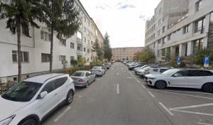 a row of white cars parked in a parking lot at MSC Apartment in Sibiu
