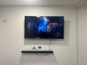 a flat screen tv hanging on a wall at EKÜ Chapa Tiny House - Playa Luna Roja in La Estafeta