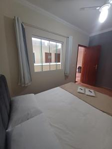 A bed or beds in a room at Pousada Estrela Mares Suíte 204