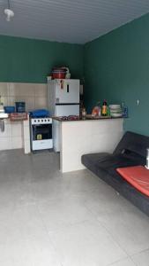 a kitchen with a counter and a refrigerator and a stove at casa de praia ReJ 2 in Itapoa