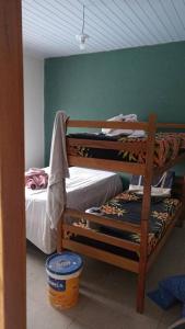 two bunk beds in a room with a bucket at casa de praia ReJ 2 in Itapoa