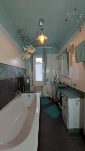 a large bathroom with a large tub and a sink at Maries bunte Villa in Bad Berleburg +89 photos