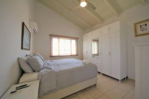 a bedroom with a bed and a couch at Paradera Paradise - your ultimate 5-bedroom getaway in Paradera +17 photos