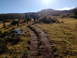 a group of people walking down a dirt road at Alojamiento Anita Habitaciòn in Monguí