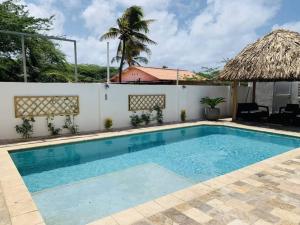 a swimming pool at a villa with a resort at Turibana Villa- 3 Bedroom, 2 Bathroom in Palm-Eagle Beach