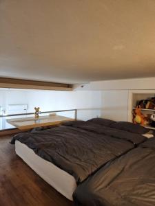a bedroom with a large bed and a wooden table at Wooyeon in Seongnam