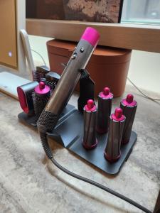 a blow dryer with a pink handle on a stand at Wooyeon in Seongnam