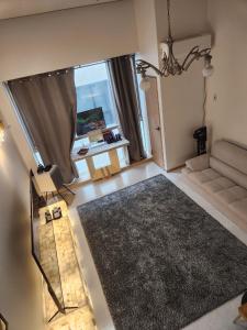 a living room with a couch and a large rug at Wooyeon in Seongnam +4 photos