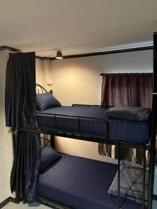 two bunk beds in a dorm room with blue mattresses at Moon Dolphin Hostel in Haad Rin