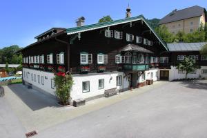 a large black and white building with flowers on it at Resl Resort in Flachau