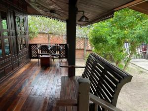 a porch with a bench on a wooden deck at Sea Beach at Lipe in Ko Lipe