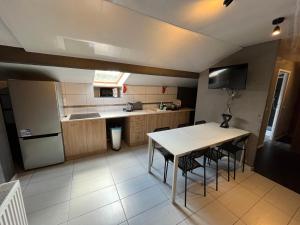 a kitchen with a table and some chairs in it at Mieszkanie na Zielonej in Olsztyn