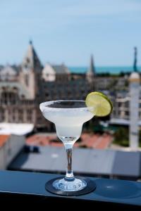 a martini glass with a lime on a table at Hotel Monarch in Batumi
