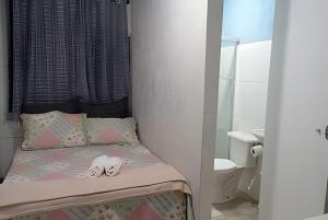 a small bedroom with a bed and a bathroom at kitnet 01 preço popular in Brasília