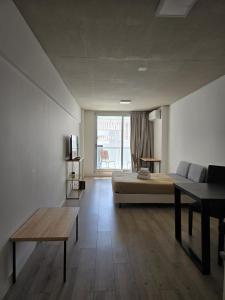 a bedroom with a bed and a couch and a table at Lure Palermo Hollywood in Buenos Aires