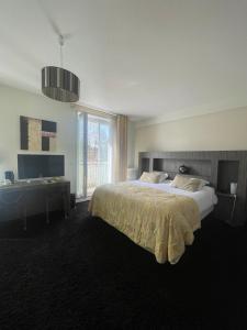 a bedroom with a large bed and a window at Hôtel La Réserve in Gérardmer