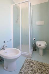 a bathroom with a shower and a toilet and a sink at La casa di Visi in Milan +4 photos