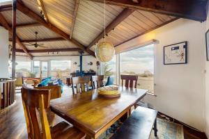 a dining room with a wooden table and chairs at Seas the Day in Sea Ranch