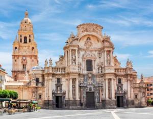 a large building with two towers on a street at Apartamento casalely in Murcia +6 photos