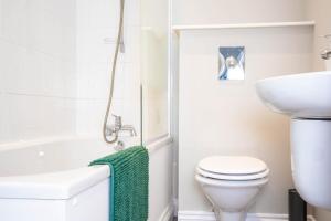a bathroom with a toilet and a sink at York Place Mews - Central 2 bed 2 bath Free Parking in Harrogate +7 photos