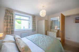 a bedroom with a large bed and a window at Fabulous Sea View Apartment in Aberdyfi