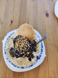 a bowl of ice cream with a cookie on top of it at Casa Rosina in San Vito lo Capo