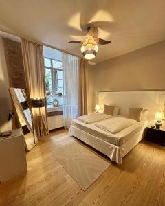 a bedroom with a bed and a ceiling fan at cinderella.kreuzberg in Berlin +11 photos