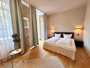 a bedroom with a bed and a large window at cinderella.kreuzberg in Berlin
