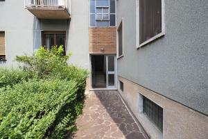 a walkway next to a building with a window at Primopiano - Avogadro in Milan