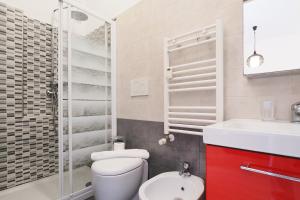 a bathroom with a white toilet and a sink at Primopiano - Avogadro in Milan +27 photos