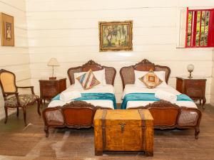a bedroom with two beds and two chairs at Casa Vieja Mountain Lodge in Ayacucho