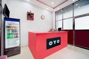 an office with a red counter with an open refrigerator at Hotel O Friends Inn in Patna
