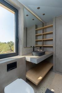 a bathroom with a sink and a mirror at Villa Fengari in Evangelismós