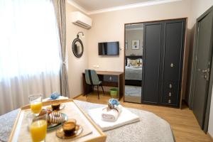 a living room with a table and a mirror at SP Urban Apartment in Plovdiv